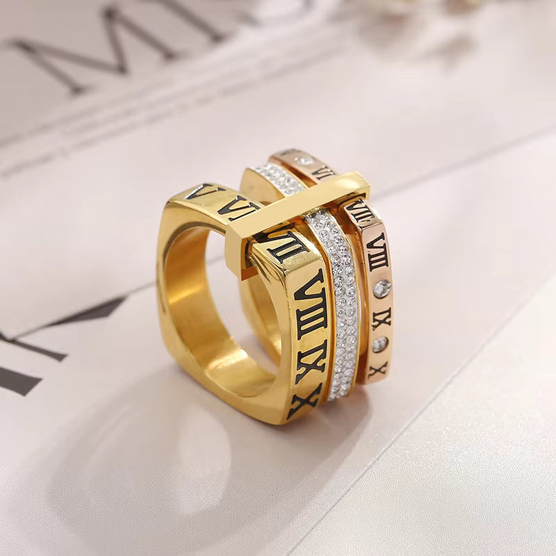 two tones Gold ring with Roman numeral design on a light fabric background