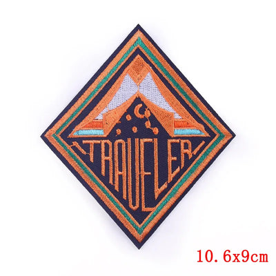 Embroidered patch with 'TRAVELER' text and mountain design on a white background
