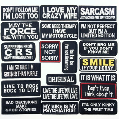 Collection of various text patches with different sayings on a black background