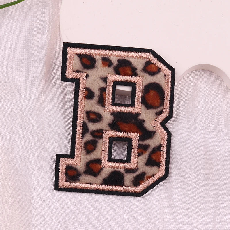 Leopard print letter 'B' patch on a white background