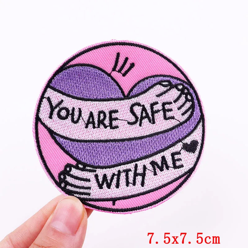 Circular patch with 'You are safe with me' text held by a hand on a white background