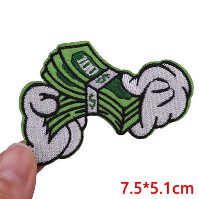 Green and gray bow tie patch held by a hand with size measurement '7.5*5.1cm' displayed.