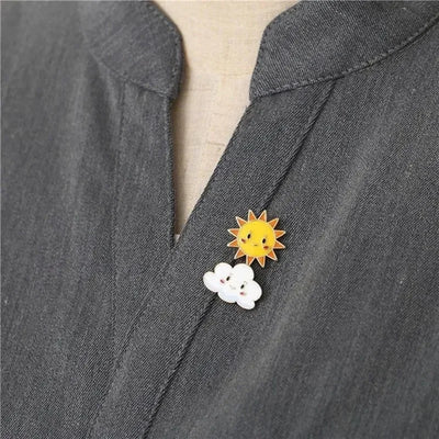 Sun and cloud brooch on a gray denim jacket