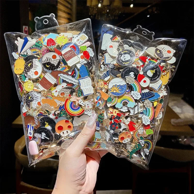 Two clear plastic packages filled with colorful pins held by a hand.