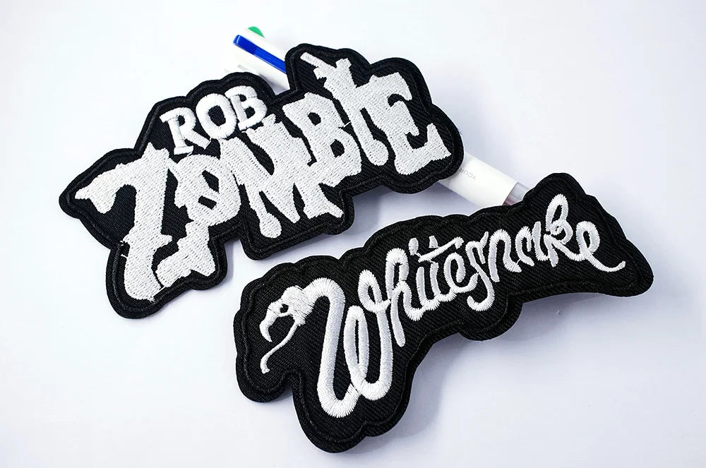 Two patches with 'Rob Zombie' and 'White Snake' text on a white background