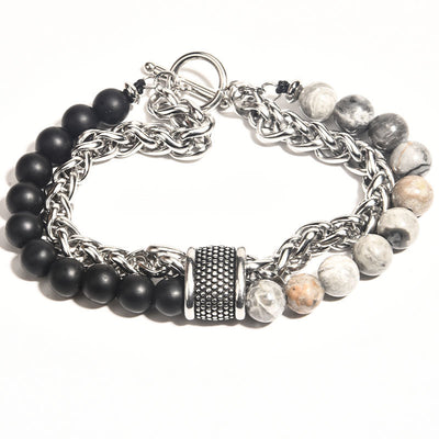 Bracelet with black beads and chain links on a white background