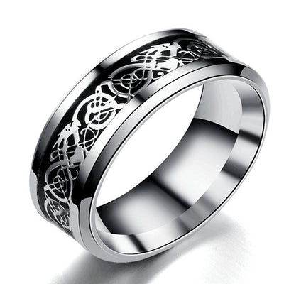 Silver ring with intricate Celtic knot design on a white background