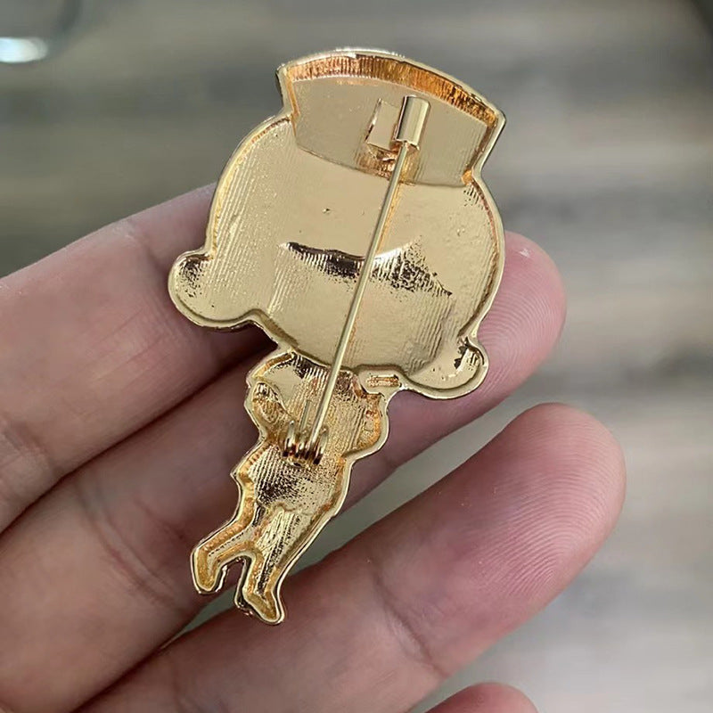 back view of the nurse cartoon pin held in a hand with a blurred backgroundbackground