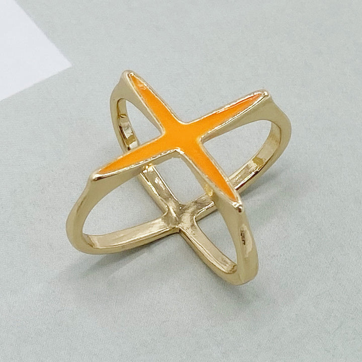 Gold ring with an orange center on a light gray background