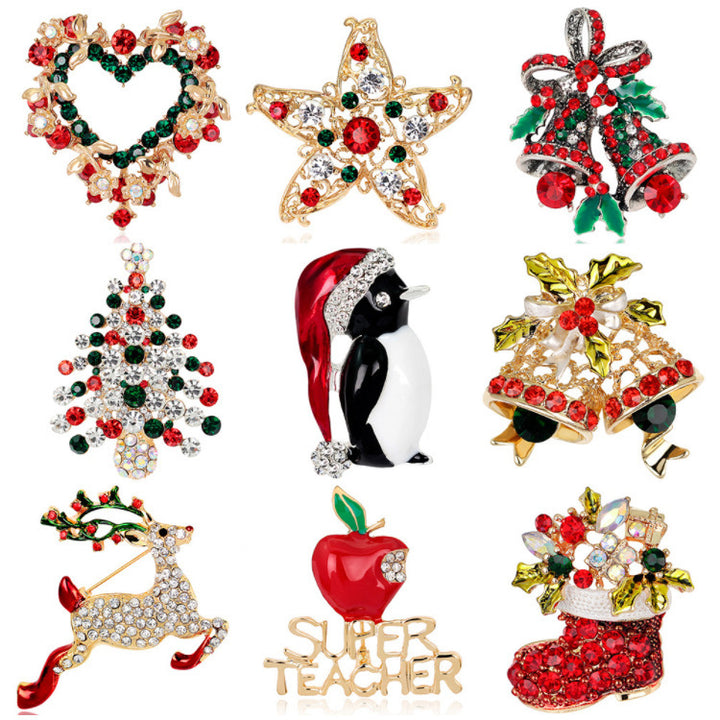 Collection of Christmas-themed brooches including a star, wreath, penguin, tree, bell, deer, apple, and &
