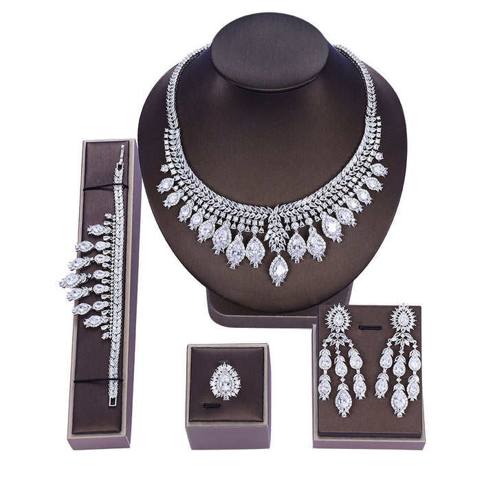 zircon Bridal Jewelry set including necklace, bracelet, ring, and earrings on a white background