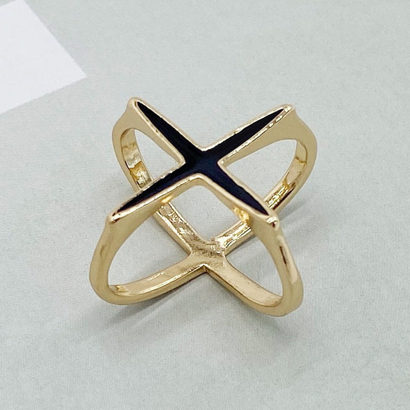 Gold ring with a blue gemstone on a light gray background
