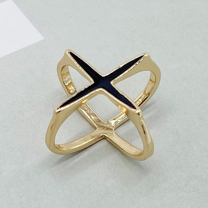 Gold ring with a blue gemstone on a light gray background
