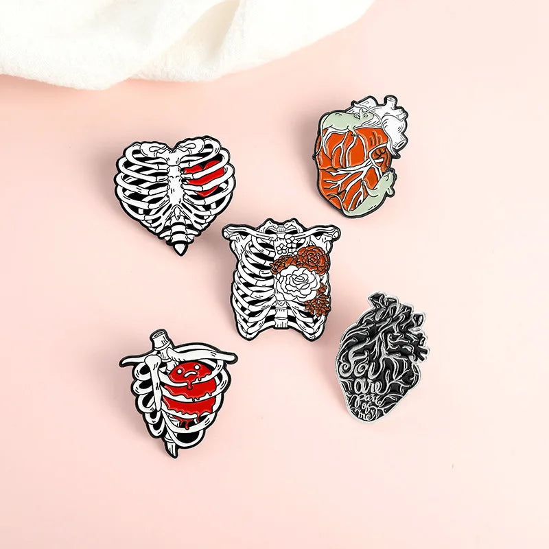 Five anatomical-themed pins on a person's arm against a light background