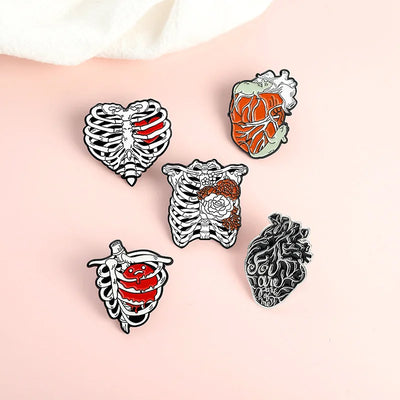 Five anatomical-themed pins on a person's arm against a light background