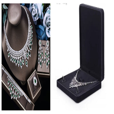 Jewelry set with necklace, earrings, and brooch in display cases.