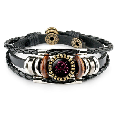 A stylish black leather bracelet featuring braided strands, decorative silver and wood beads, and a central purple gem with a circular gear-like frame.