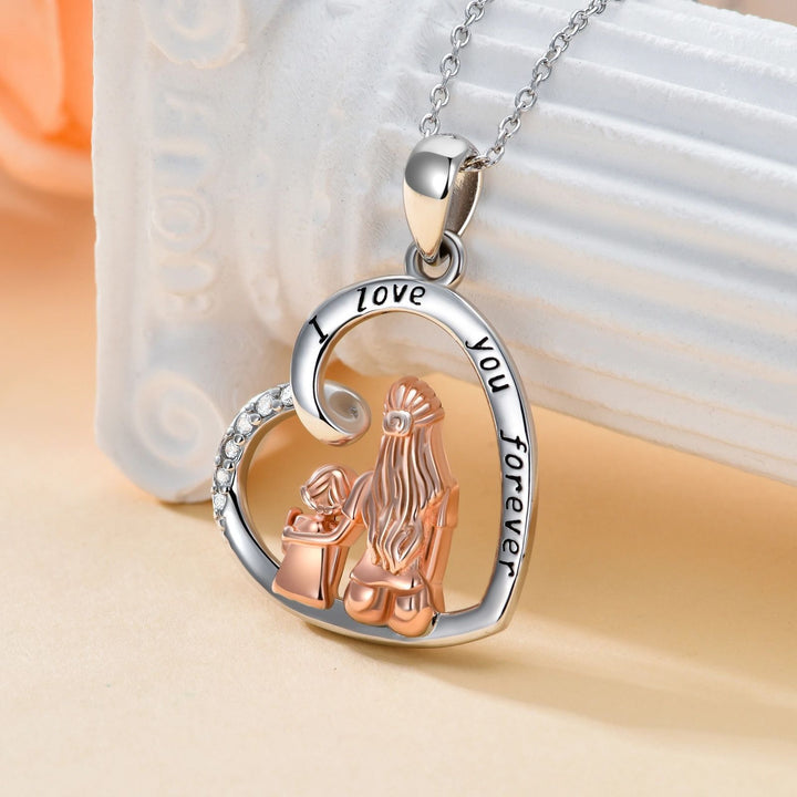 Heart-shaped pendant with two clasped hands and &