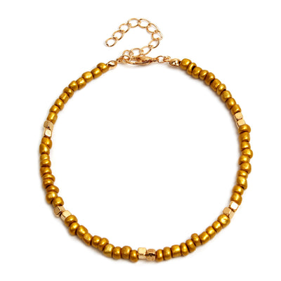 Gold beaded anklet  on a white background