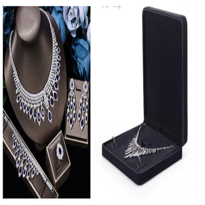 Jewelry set including necklace, earrings, and brooch in display cases.