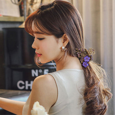 Woman with styled hair featuring a decorative hair accessory, indoors.