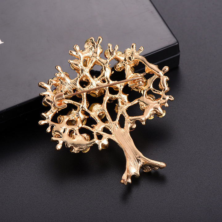 back side of the Gold tree-shaped brooch on a black background