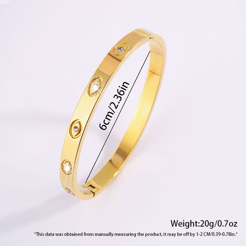 Gold bracelet with measurement details on a white background