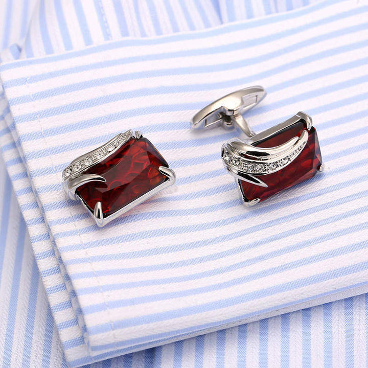 Red and silver cufflinks on a blue and white striped shirt