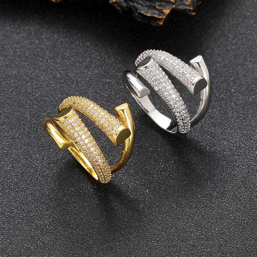 Gold and silver Zircon rings on a dark textured surface