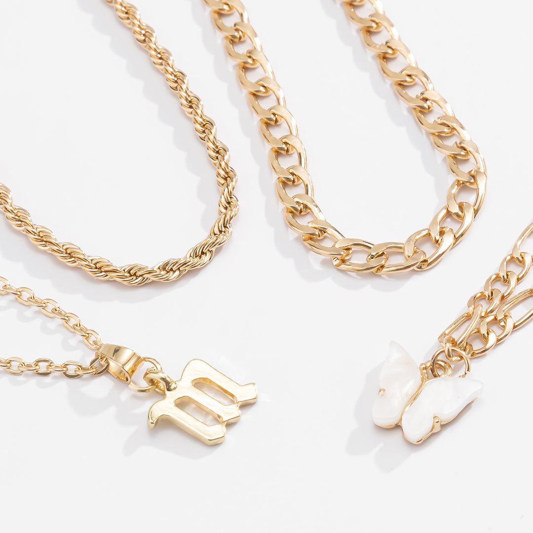 Gold anklets with various designs on a light background