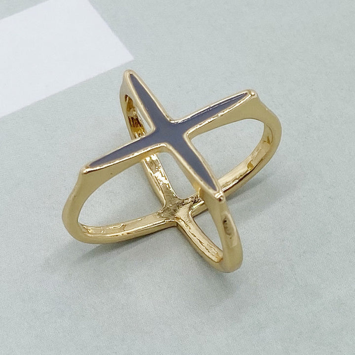 Gold ring with a blue stone on a light gray background
