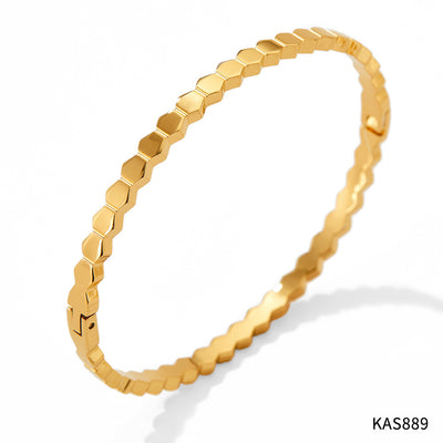Gold bracelet with hexagonal pattern on a white background
