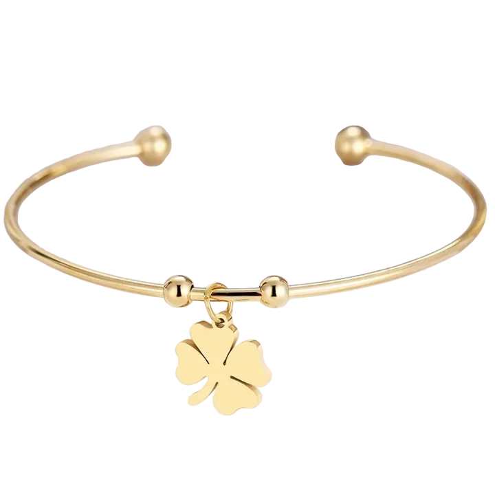 Gold bracelet with a four-leaf clover charm on a white background