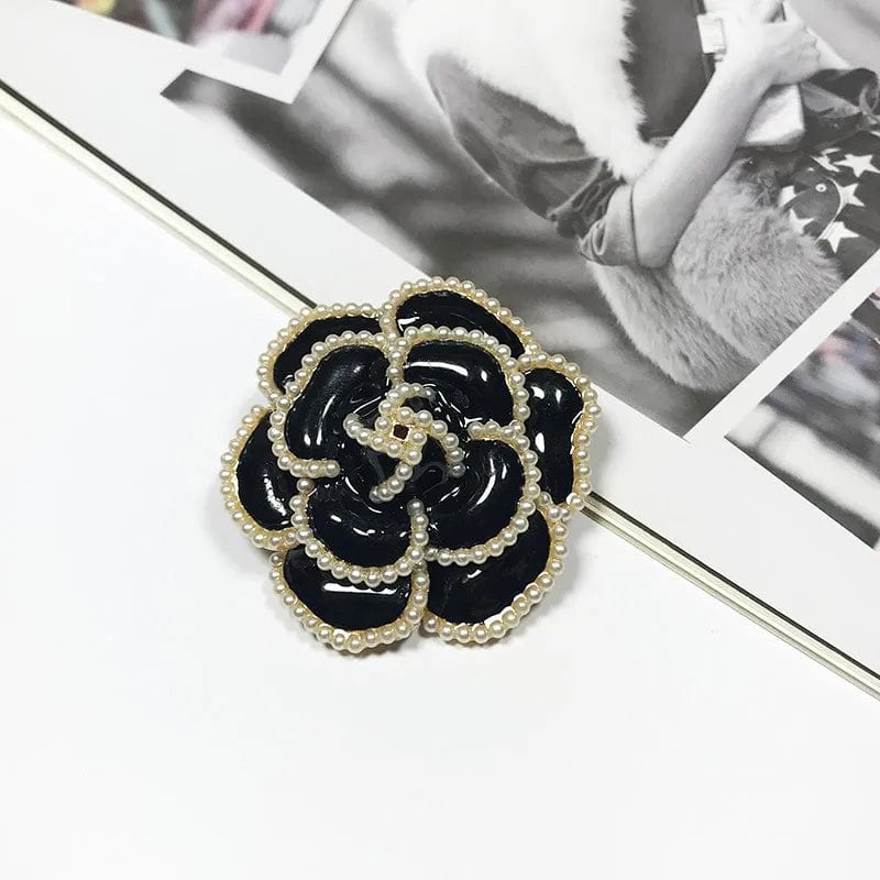 black camellia flowers pearl brooches on a picture