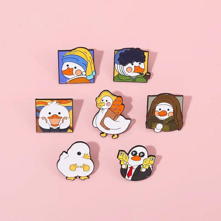 Set of cartoon duck pins on a pink background