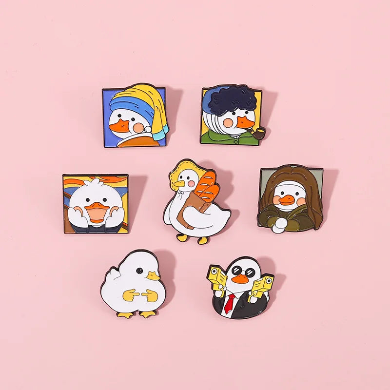 Set of cartoon duck pins on a pink background