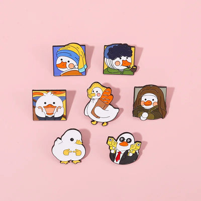 Set of cartoon duck pins on a pink background