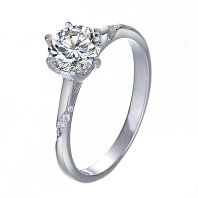 Silver ring with a large diamond on a white background