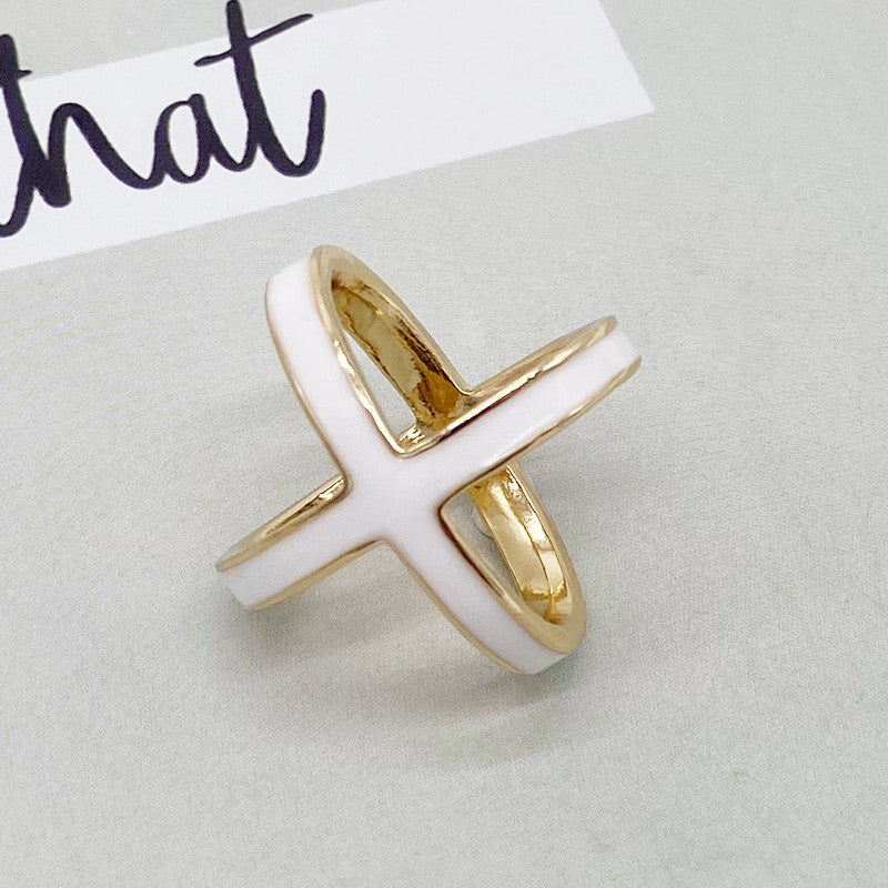 Gold and white ring on a light gray background with &