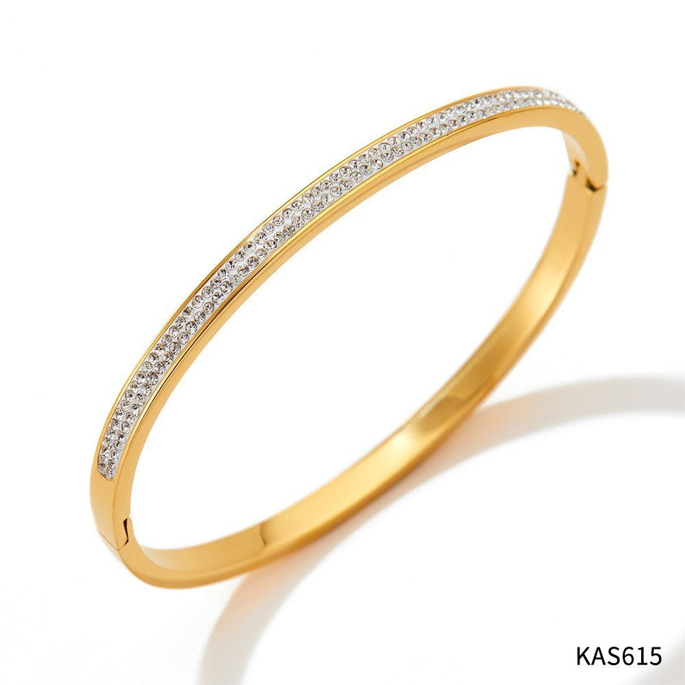 Gold bracelet with diamonds on a white background