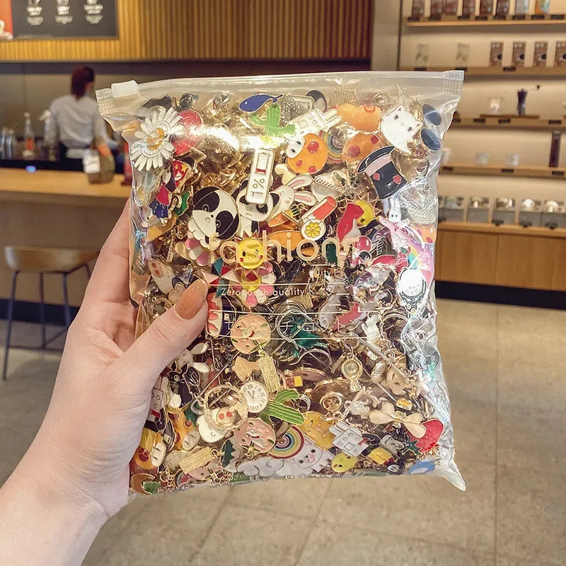 Hand holding a clear bag filled with various colorful pins in a casual setting.