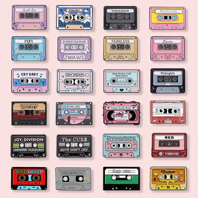 Collection of colorful cassette tapes enamel pins with various designs on a pink background