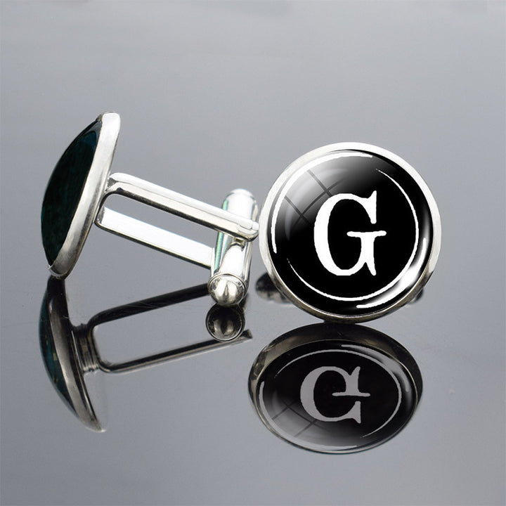 Cufflinks with a black round design featuring a white letter &