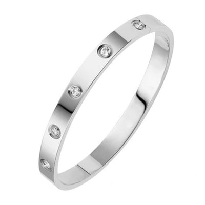 Silver ring with small diamonds on a white background
