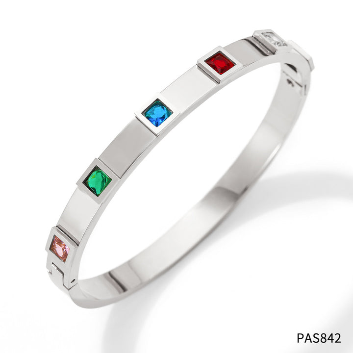 Silver bracelet with colorful gemstones on a white background