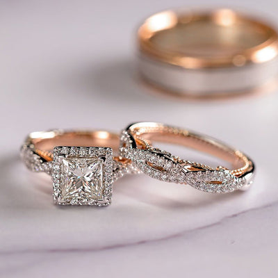 Two rose gold diamond rings on a light background