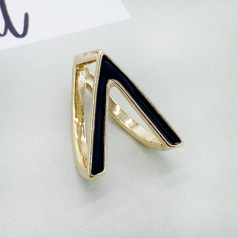 Gold ring with a black triangle on a white background