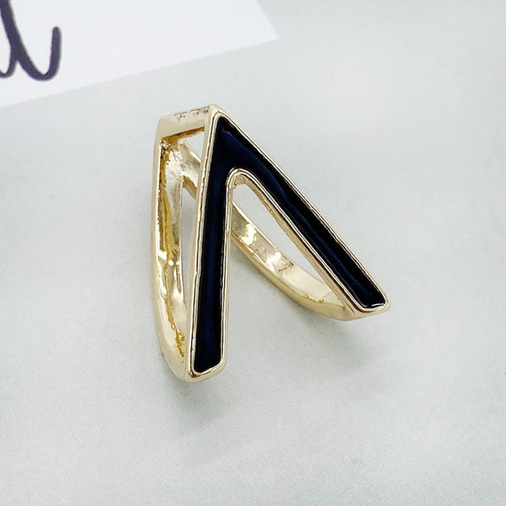 Gold ring with a black triangle on a white background