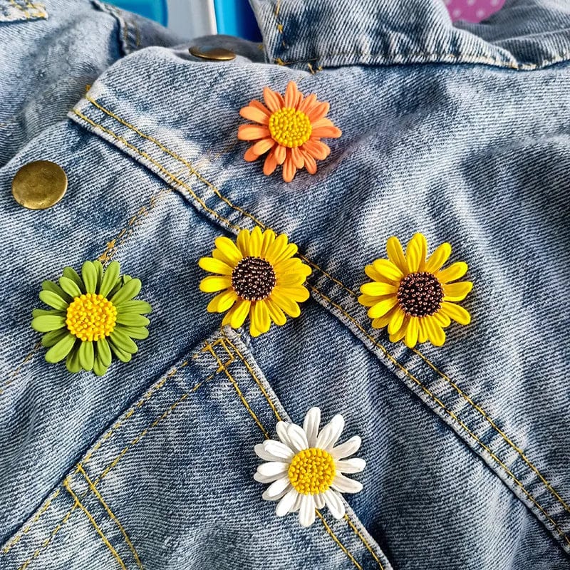 another set of little daisy brooch of different colors on a jeans