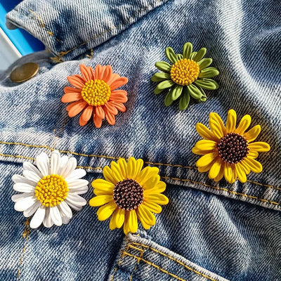 little daisy brooch of different colors on a jeans